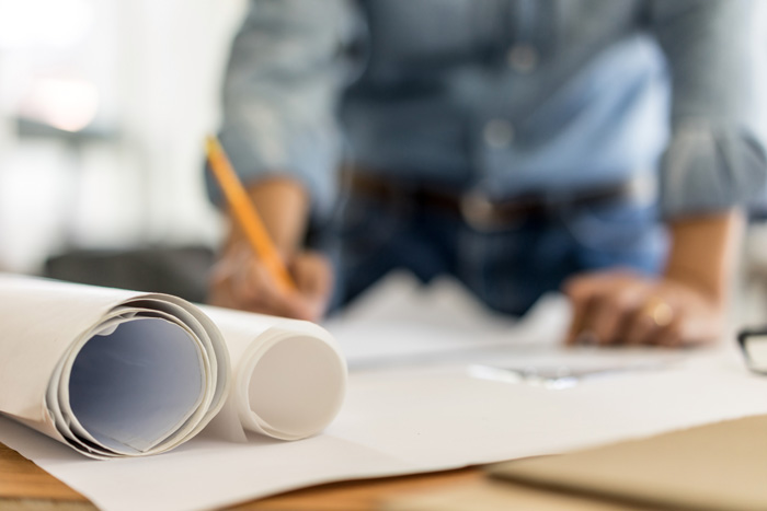 rolled paper with out of focus person writing