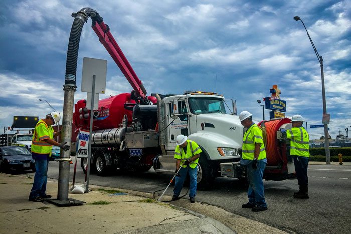 crew doing electrical work on sidewalk